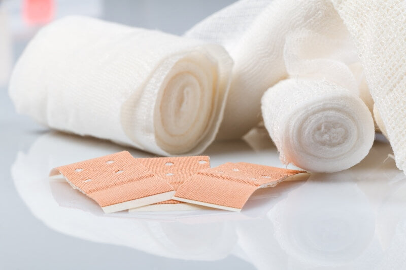 Image with colorful bandages and rolls of bandages - buy bandage materials now!